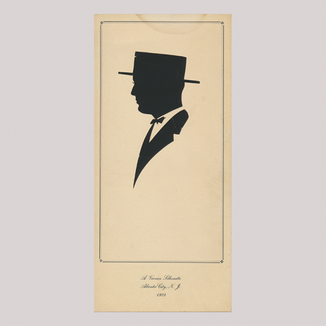 
        Front of silhouette, with man looking left, in suit and wearing a hat, in painted square frame.